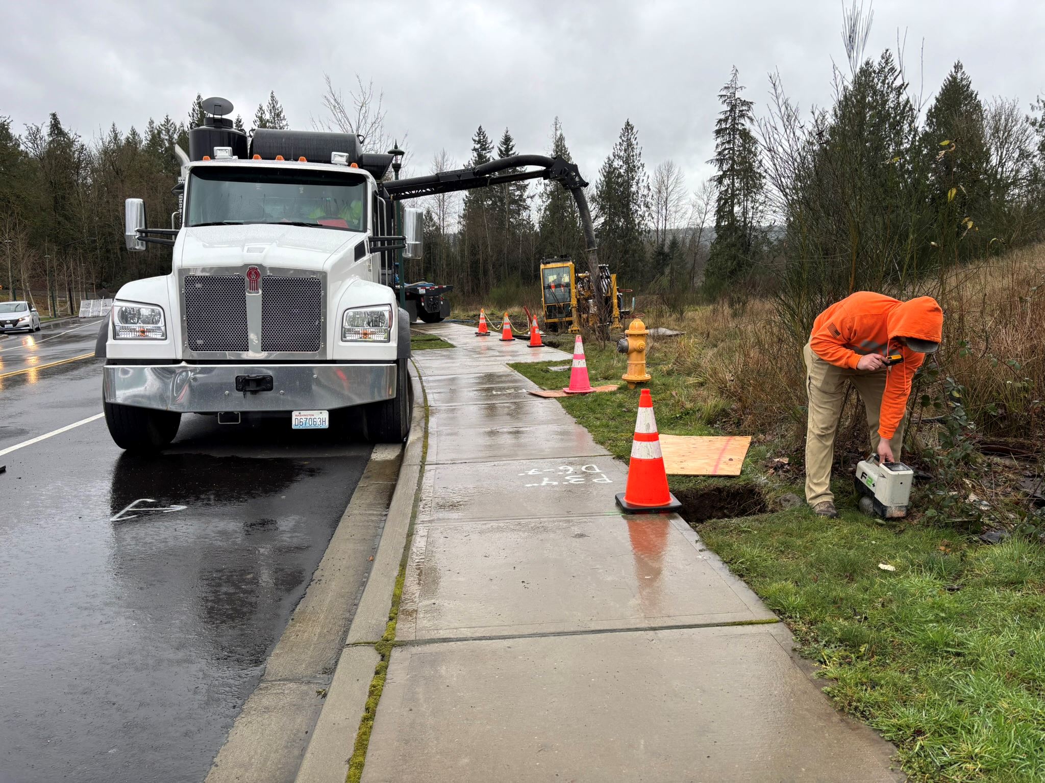 A drilling technician using monitoring equipment to track the drilling head underground.