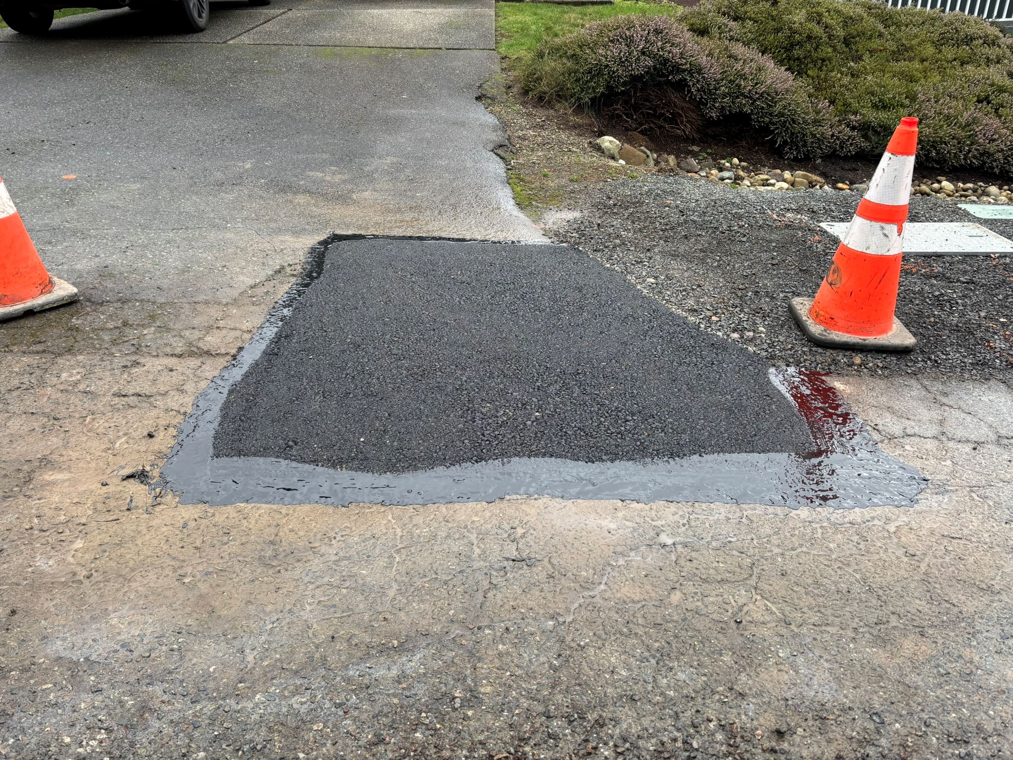 Image of a new asphalt patch with sealed edges